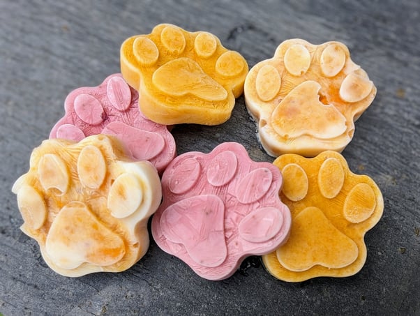 Frozen dog treats in the shape of paws.