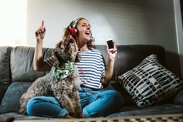 Dog singing with human listening to music